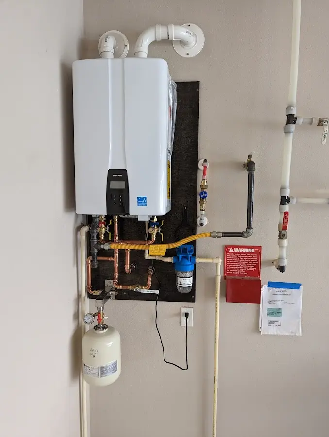 Professional plumber installing copper piping in a Weirton home